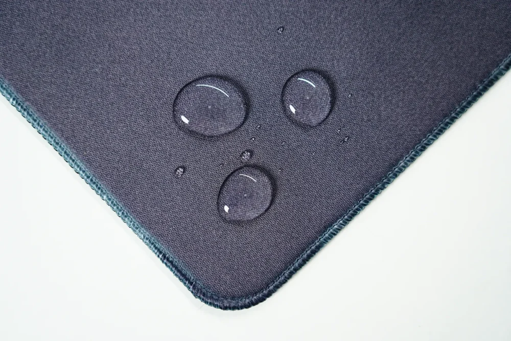 Ronaldinho Barcelona desk mat surface with water droplets staying on top, showing spill-resistant fabric for safer daily use