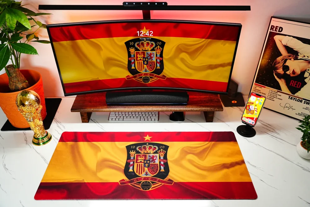 Spain Football Team Desk Mat shown in a coordinated football desk setup with matching screen artwork, World Cup trophy, and daily workspace layout