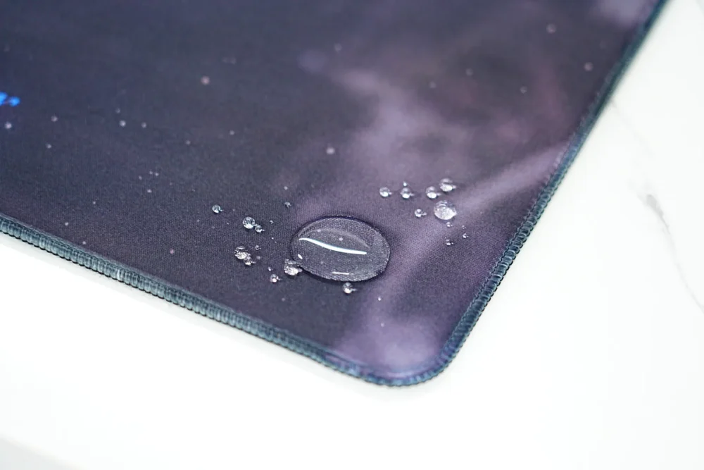 Water droplets stay on basketball mouse pad fabric, showing protection against water and drink soaking