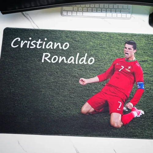 Close-up of Cristiano Ronaldo mouse pad showing Portugal knee-slide artwork, name lettering, grass texture and stitched edge