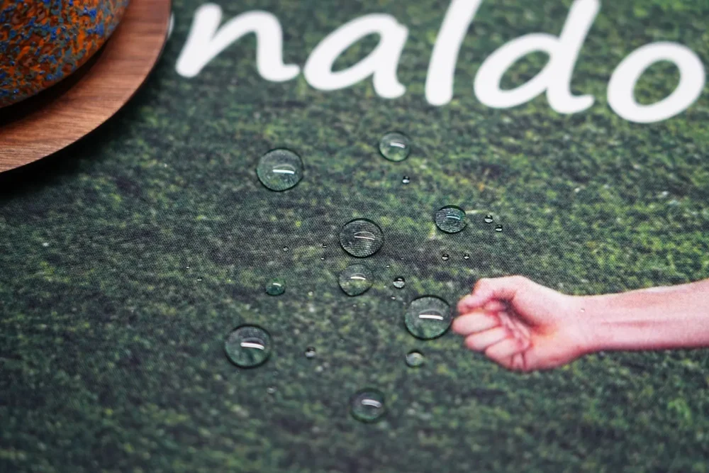 Water droplets beading on the Cristiano Ronaldo mouse pad fabric to demonstrate its spill-resistant surface