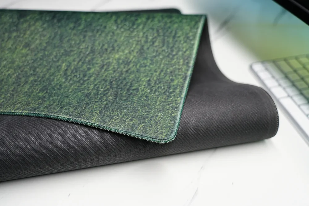 Close-up of Cristiano Ronaldo mouse pad with stitched edge and textured anti-slip rubber base, shown with one corner lifted