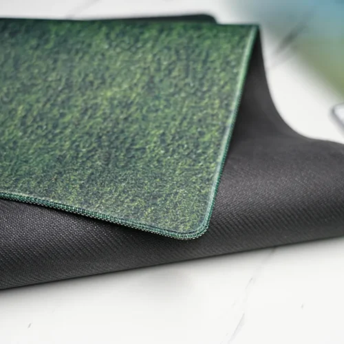 Close-up of Cristiano Ronaldo mouse pad with stitched edge and textured anti-slip rubber base, shown with one corner lifted