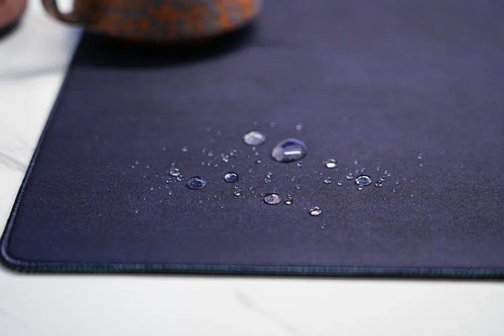Water droplets on the spill-resistant surface of a Kobe Bryant Lakers desk mat