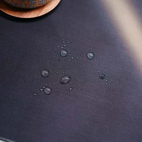 Water drops beading on the Lionel Messi Argentina World Cup desk mat spill-resistant cloth surface