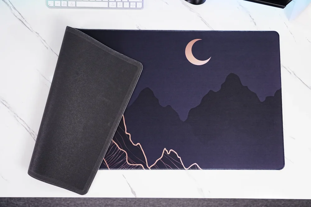 Crescent Moon Mountain mouse pad close-up showing stitched edge and rubber base