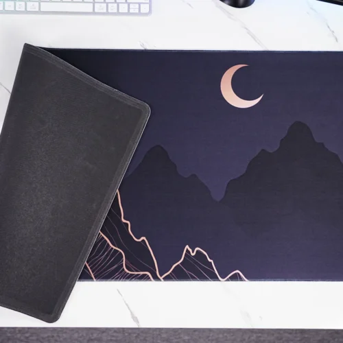 Crescent Moon Mountain mouse pad close-up showing stitched edge and rubber base
