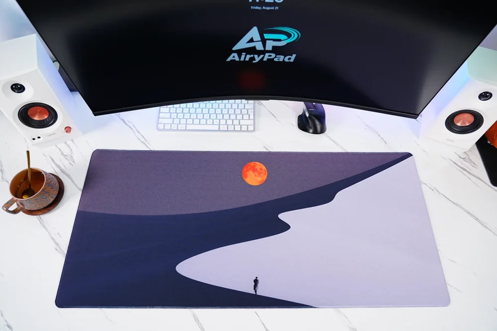 Orange Moon Desert Walker desk mat with keyboard and mouse showing orange moon desert artwork