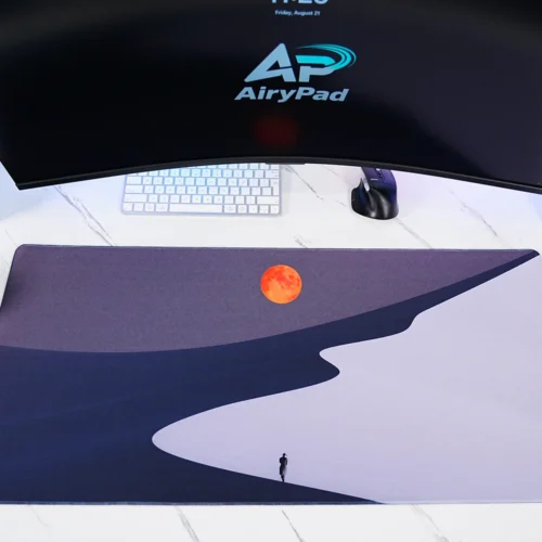Orange Moon Desert Walker desk mat with keyboard and mouse showing orange moon desert artwork