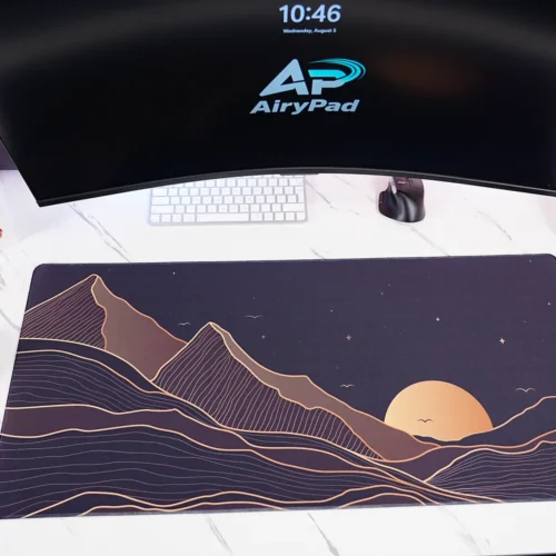 Starry Mountain Sunset desk mat under a curved monitor with keyboard and mouse