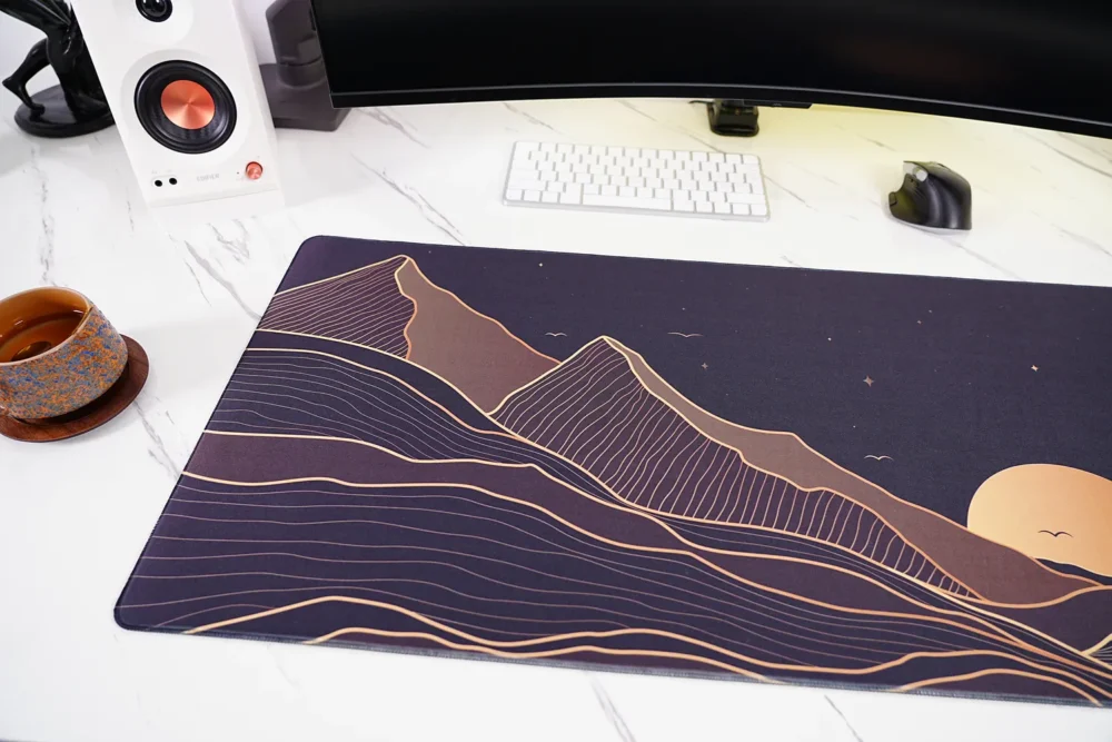 Close-up of Starry Mountain Sunset desk mat showing mountain landscape artwork detail