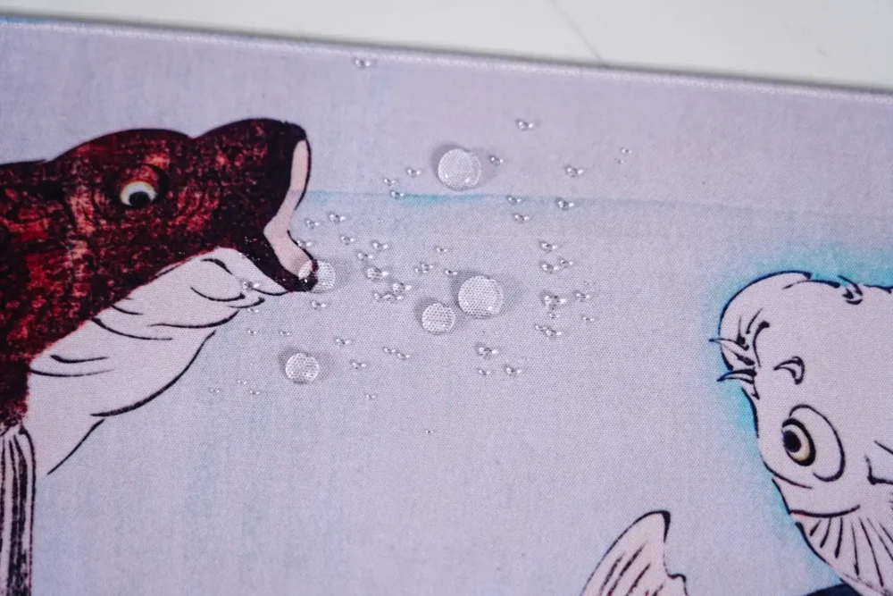 Water-Resistant Koi Fish Mouse Pad Surface Water-resistant koi fish mouse pad surface with water droplets close-up